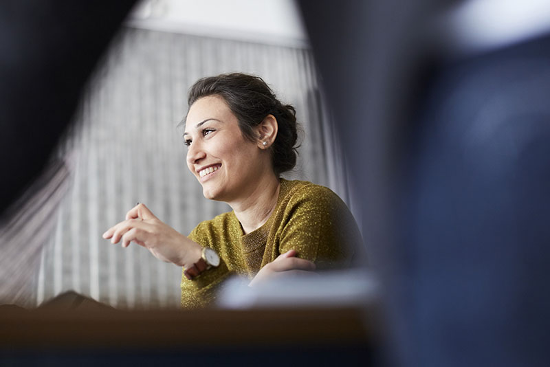 Smiling businesswoman sitting in front of female colleague at creative office