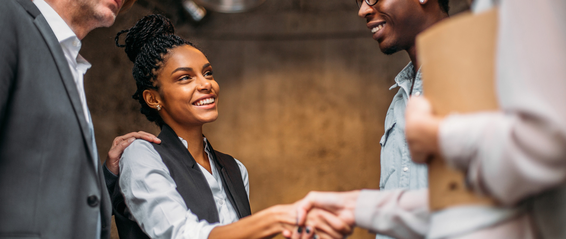 Business partners greeting new colleagues, welcoming their joining to the firm