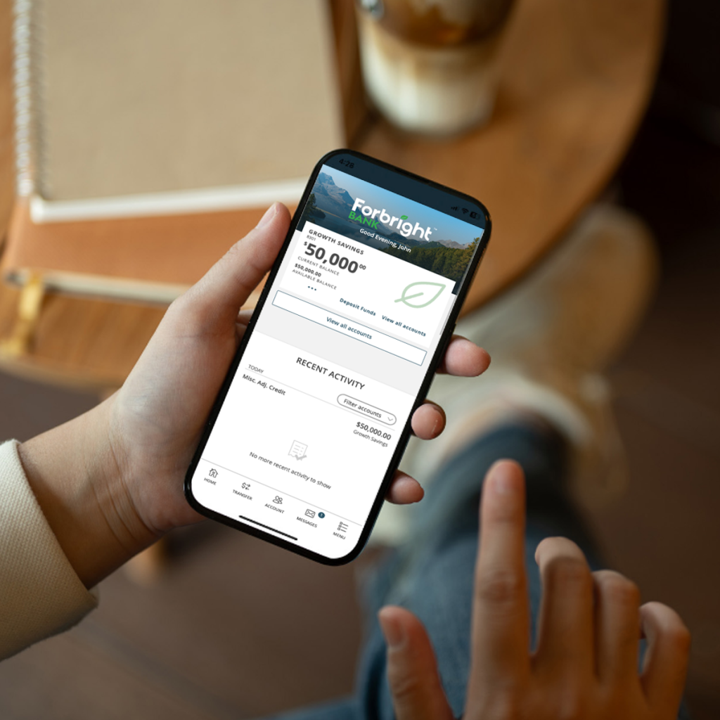 hand holding smartphone with Forbright Bank on screen