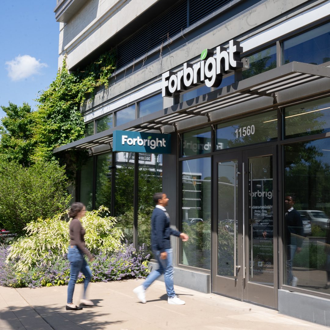 Two people entering a Forbright Bank Service Hub location