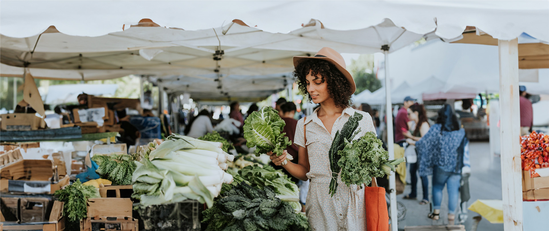 Young black woman shopping at a farmer's market.