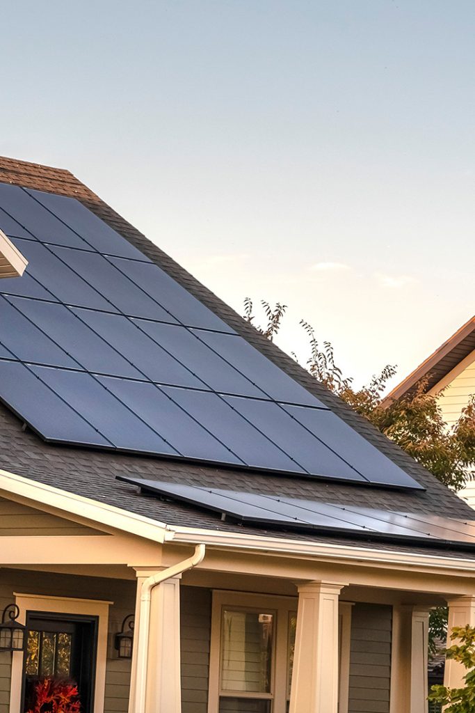 Single-family home with solar panels installed on the roof.