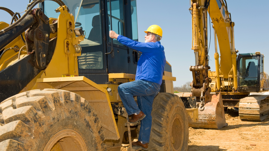 Man getting on construction equipment